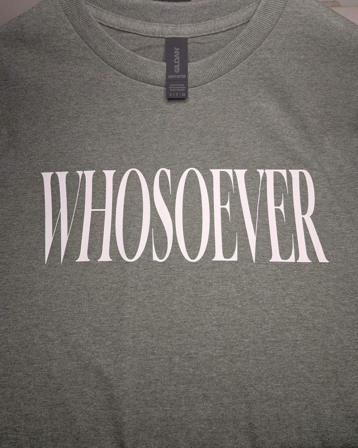 Close-up of the pressed lettering and the neck label on a heathered shirt.